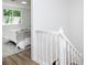Upstairs hallway with white railing and view into bedroom at 2371 Wingfoot Pl, Decatur, GA 30035
