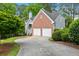 Brick and siding house with a two-car garage and a paved driveway at 135 River Point Ct, Alpharetta, GA 30022