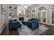 Elegant living room with a fireplace, built-in shelves, and blue velvet sofas at 302 Rolling Rock Se Rd, Marietta, GA 30067