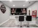 Basement bar with black tile backsplash and granite countertop at 302 Rolling Rock Se Rd, Marietta, GA 30067