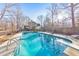 Relaxing inground pool with diving board, surrounded by trees at 98 Due West Ct, Dallas, GA 30157