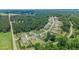 An aerial view of new neighborhood featuring well-maintained lawns and mature trees at 125 Registry Ln, Canton, GA 30115