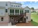 Spacious backyard with a screened-in porch and wooden stairs with brick foundation at 125 Registry Ln, Canton, GA 30115