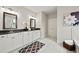 Elegant bathroom with double vanity, black granite counters, and decorative floral arrangement at 125 Registry Ln, Canton, GA 30115