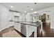 Modern kitchen island featuring dark countertops, stainless steel appliances, and an open view to the living area at 125 Registry Ln, Canton, GA 30115