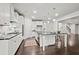 Bright, modern kitchen with stainless steel appliances and dark countertops, opening to the living room at 125 Registry Ln, Canton, GA 30115