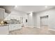 Bright kitchen area features white cabinets and stainless steel fixtures, with open floor plan at 125 Registry Ln, Canton, GA 30115