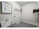 The laundry room features a utility sink, tile floor, and wire shelving for organized storage at 125 Registry Ln, Canton, GA 30115