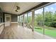 The screened porch has a ceiling fan, with an outdoor view of a green lawn and trees at 125 Registry Ln, Canton, GA 30115