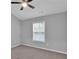 Bedroom featuring a ceiling fan, vaulted ceiling, a window and neutral carpeting at 593 Woodland Park Ter, Lawrenceville, GA 30043