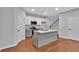 Modern kitchen featuring white cabinets, granite countertops and a central island at 593 Woodland Park Ter, Lawrenceville, GA 30043