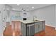 Open kitchen featuring a granite island, stainless steel appliances and hardwood floors at 593 Woodland Park Ter, Lawrenceville, GA 30043