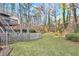 Large backyard with tree-filled wooded area and a trampoline at 695 Arboreal Ct, Alpharetta, GA 30022