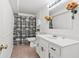 Basement bathroom with white vanity and black and white shower curtain at 695 Arboreal Ct, Alpharetta, GA 30022