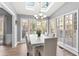 Sun-drenched dining room with a view of the backyard and seating for six at 695 Arboreal Ct, Alpharetta, GA 30022