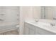 Bright bathroom featuring double sink vanity, modern fixtures and white bathtub with shower at 989 Blue Juniper Cir, Loganville, GA 30052