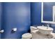 Modern powder room with a white sink and blue walls at 345 Commons Ave, Woodstock, GA 30188