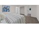 Spacious bedroom with striped bedding and access to hallway at 4701 Flat Shoals Rd # 56E, Union City, GA 30291