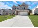 Two-story home with gray siding, two-car garage, and a landscaped lawn at 3069 Shirecrest Ln, Dacula, GA 30019