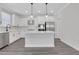 Modern kitchen with white cabinets, center island, and stainless steel appliances at 3069 Shirecrest Lane, Dacula, GA 30019