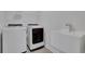 Bright laundry room with washer, dryer, and utility sink at 3069 Shirecrest Lane, Dacula, GA 30019