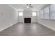 Living room with fireplace, gray vinyl plank flooring, and ceiling fan at 3069 Shirecrest Lane, Dacula, GA 30019