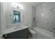 Clean bathroom, gray vanity, marble shower, and bathtub at 5271 Lake Forrest Dr, Atlanta, GA 30342