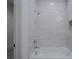 Bathroom with shower/tub combo and white tile at 5271 Lake Forrest Dr, Atlanta, GA 30342