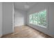 Bright bedroom with hardwood floors and large window at 5271 Lake Forrest Dr, Atlanta, GA 30342