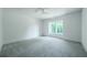 Bright bedroom with gray carpeting and a large window at 5271 Lake Forrest Dr, Atlanta, GA 30342