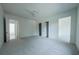 Spacious bedroom with gray carpeting and multiple doorways at 5271 Lake Forrest Dr, Atlanta, GA 30342