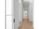 Bright hallway with hardwood floors and white walls at 5271 Lake Forrest Dr, Atlanta, GA 30342