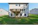 Backyard featuring a two-story house with a wooden deck overlooking a lush lawn at 7268 Eton Ln, Locust Grove, GA 30248