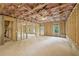 Spacious unfinished basement with stud framing, windows, and walkout door for easy customization at 7268 Eton Ln, Locust Grove, GA 30248