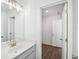Bright bathroom featuring a white vanity with a stylish faucet and wood-look flooring at 7268 Eton Ln, Locust Grove, GA 30248