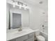 A bright bathroom with a white vanity, stylish fixtures, and a shower-tub combo at 7268 Eton Ln, Locust Grove, GA 30248