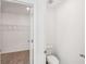 Bathroom features a toilet and a doorway to a walk-in closet at 7268 Eton Ln, Locust Grove, GA 30248