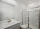 Modern bathroom featuring white cabinetry, glass-enclosed shower, and a stylish faucet enhancing this bright space at 7268 Eton Ln, Locust Grove, GA 30248