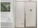 Bathroom featuring a tub with shower and a sliding glass shower door at 7268 Eton Ln, Locust Grove, GA 30248