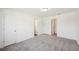 A spacious carpeted room with multiple doors offering flexible layout options at 7268 Eton Ln, Locust Grove, GA 30248