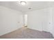 A carpeted room with multiple doors offering flexible layout options at 7268 Eton Ln, Locust Grove, GA 30248