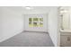 A bright bedroom with natural light from three windows and neutral carpeting at 7268 Eton Ln, Locust Grove, GA 30248