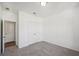 Neutral bedroom featuring a light carpet, white walls, an overhead light and a double door closet at 7268 Eton Ln, Locust Grove, GA 30248