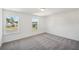 Well-lit bedroom featuring plush neutral carpeting and large windows offering bright natural light at 7268 Eton Ln, Locust Grove, GA 30248