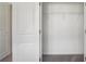 An organized closet with metal shelving, offering ample storage and a door view into a carpeted bedroom at 7268 Eton Ln, Locust Grove, GA 30248