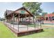 Locust Grove community area with wooden pavilion, picnic tables, and manicured lawn at 7268 Eton Ln, Locust Grove, GA 30248