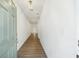 Bright entryway showcasing wood floors and a light fixture providing an inviting path through the home's neutral interior at 7268 Eton Ln, Locust Grove, GA 30248