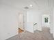 Second floor hallway featuring neutral carpet at 7268 Eton Ln, Locust Grove, GA 30248