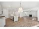 Open-concept floorplan with kitchen island and fireplace is great for entertaining at 7268 Eton Ln, Locust Grove, GA 30248