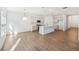 Spacious open-concept living area with updated kitchen and wood-look flooring throughout at 7268 Eton Ln, Locust Grove, GA 30248